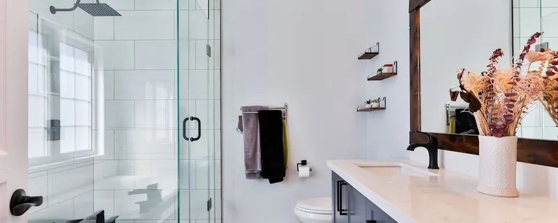 Freshly renovated bathroom with walk-in shower, vanity, and clean tile work